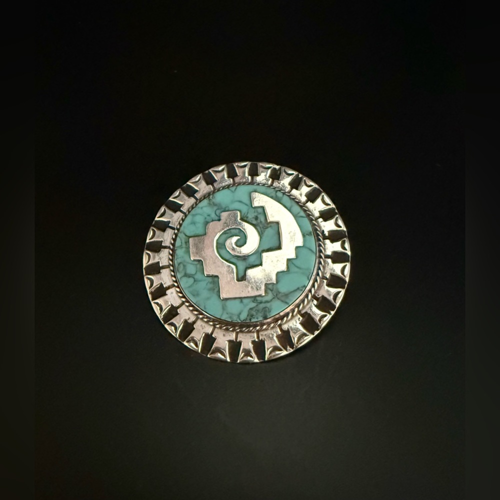 Brooch or pendant composed of silver & crushed turquoise add lively pop color.